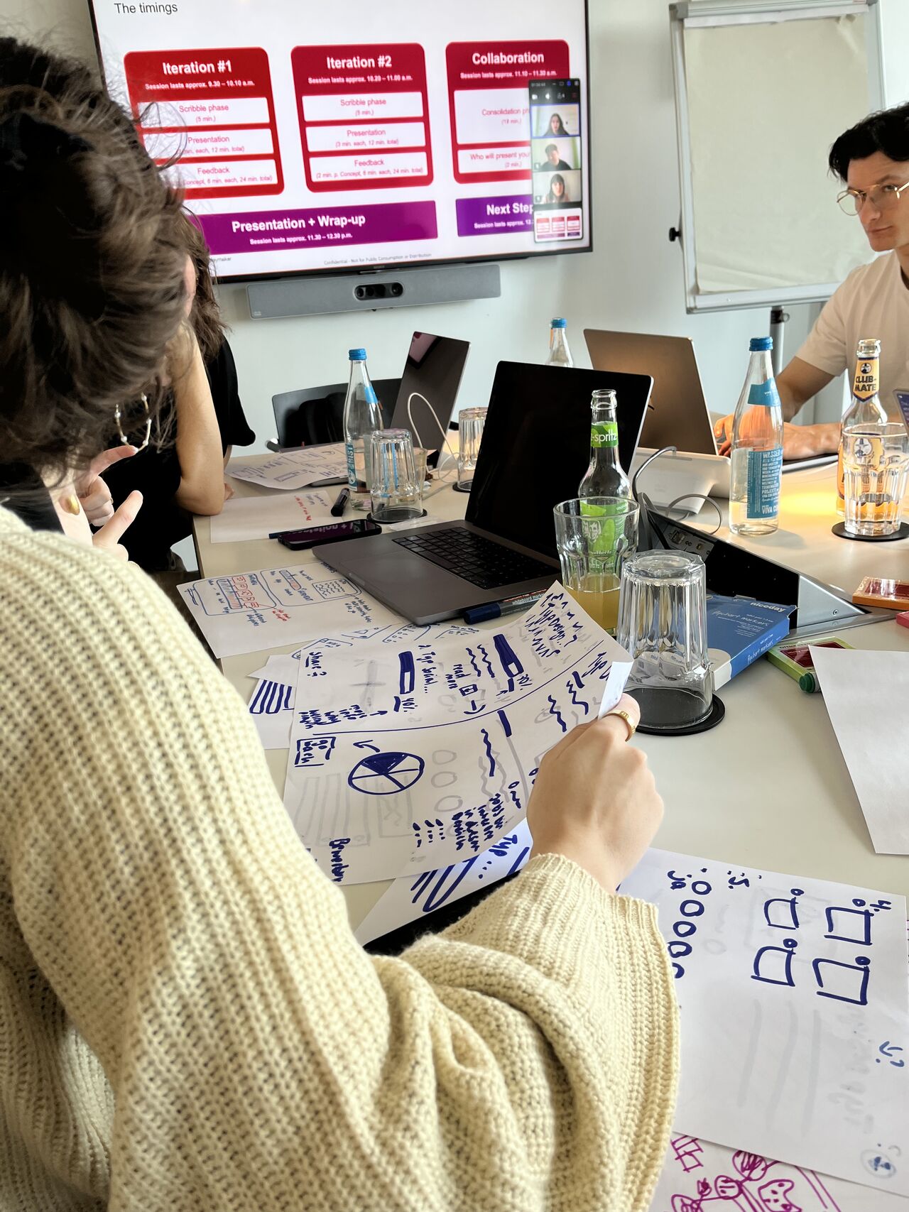 Sketching wireframes on paper during the design studio
